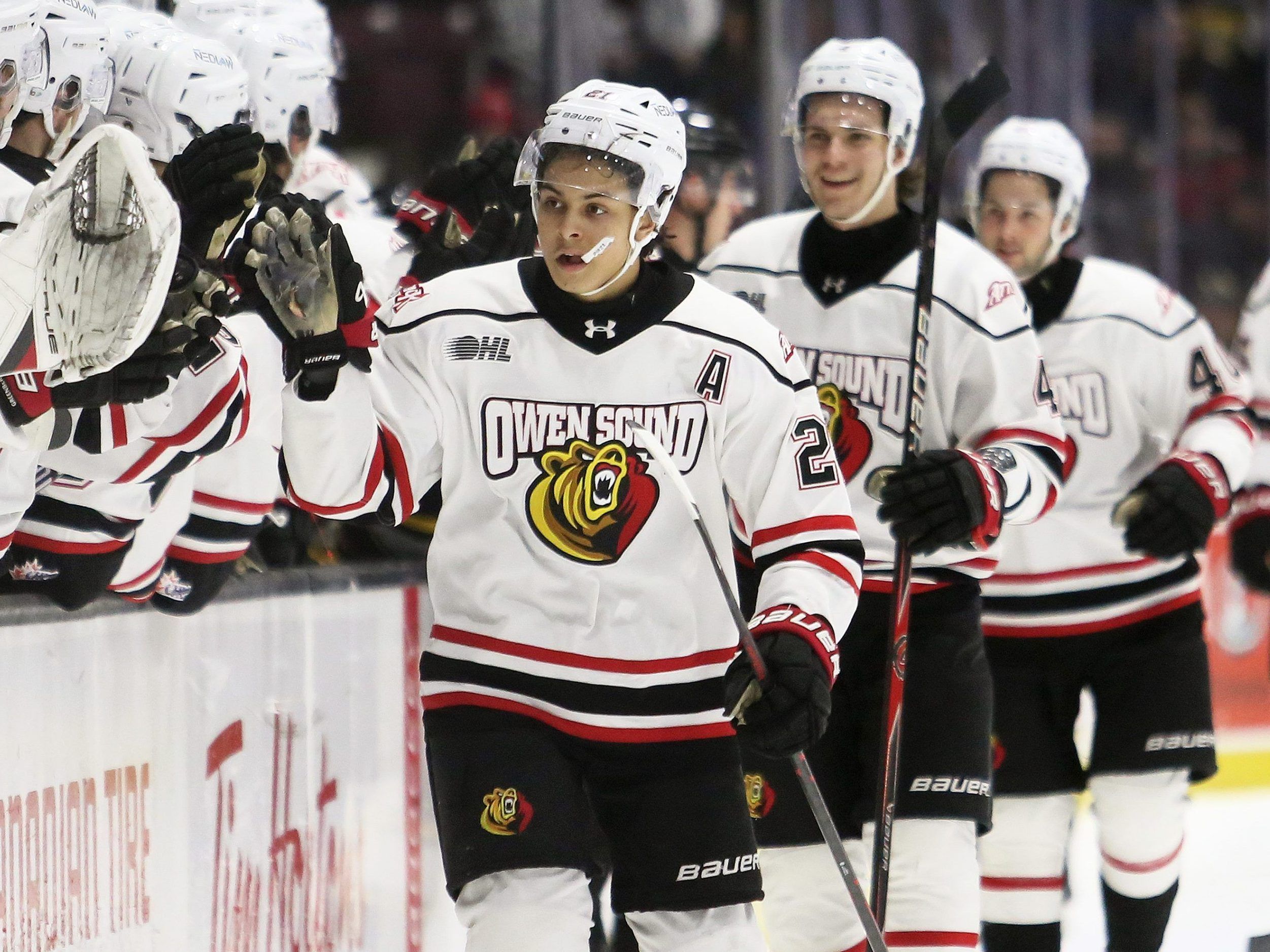 Owen Sound Attack's Pierce Mbuyi (21) is congratulated after scoring against the Sarnia Sting in the first period at Progressive Auto Sales Arena in Sarnia, Ont., on Friday, Jan. 2, 2026. Mark Malone/Chatham Daily news/Postmedia Network
