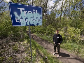 James Braakman, president of the Windsor-Essex Bike Community is shown near a vandalized sign at the Black Oak Heritage Park
