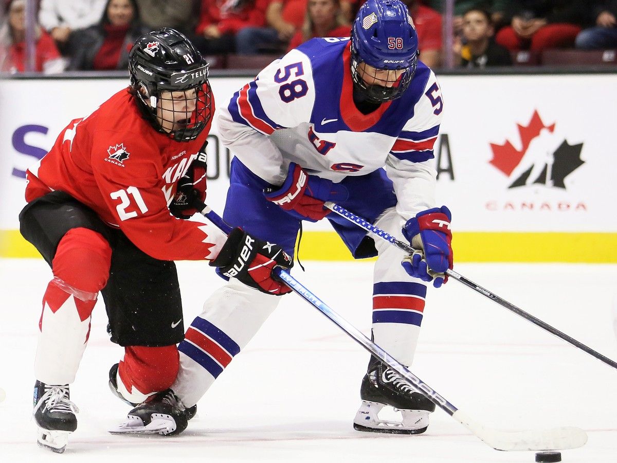 Newly signed Windsor Spitfires' defenceman Sam Wathier, at right, is seen battling Canada Red's Joe Iginla during the World Under-17 Hockey Challenge.