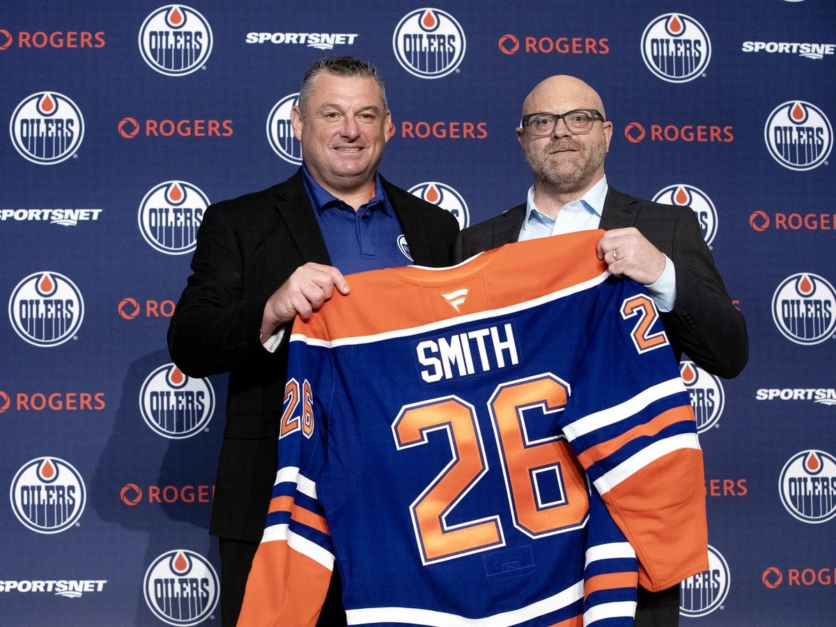 Former Windsor Spitfires' captain and coach D.J. Smith, at left, is announced as the Edmonton Oilers' new associate coach by general manager Stan Bowman during a press conference at Rogers Place, in Edmonton on Tuesday.