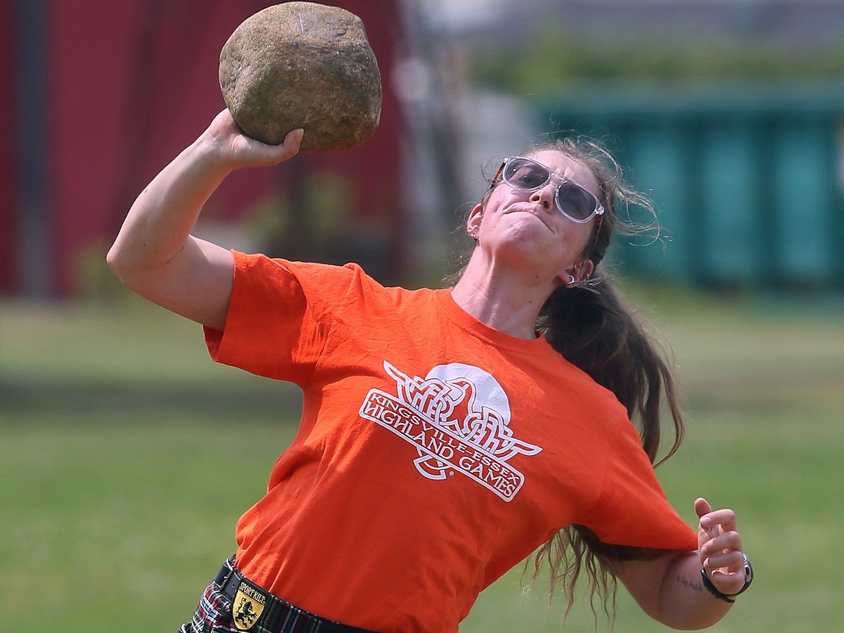 Banyan Lehman heaves a stone during a media preview of the Kingsville Highland Games
