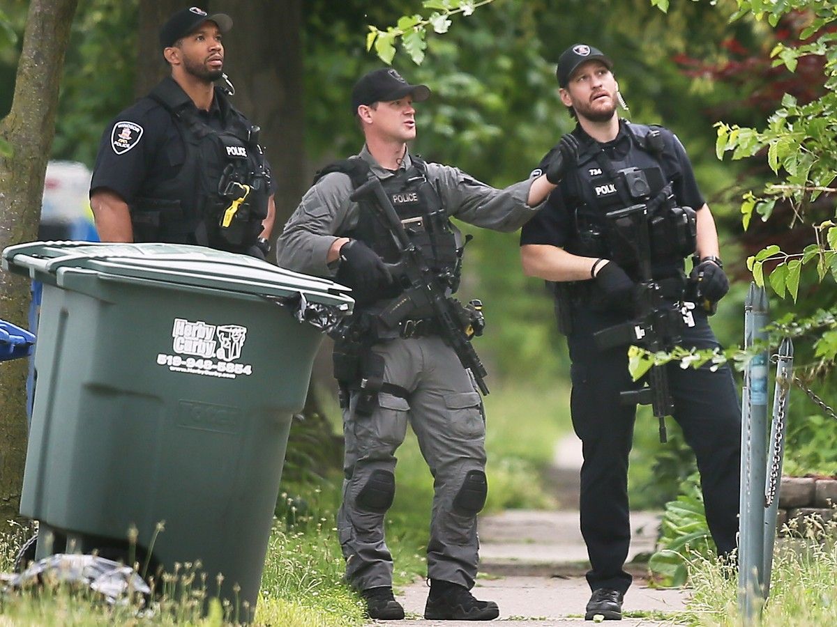 A home in the 300 block of McEwan Avenue is surrounded Thursday morning where police say a suspect, armed with a butcher knife, is located.
