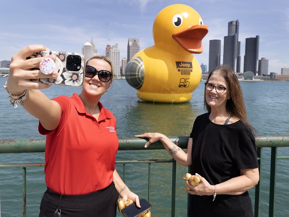 Samantha Zak and her mother Anita Zak snap a photo with a massive rubber duck