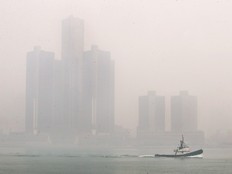 A tugboat moves along the Detroit River
