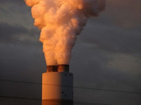 Emissions spew out of a smoke stack.