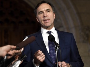 Minister of Finance Bill Morneau speaks to reporters in the Foyer of the House of Commons on Parliament Hill following Question Period, in Ottawa on Thursday, Oct. 26, 2017. THE CANADIAN PRESS/Justin Tang