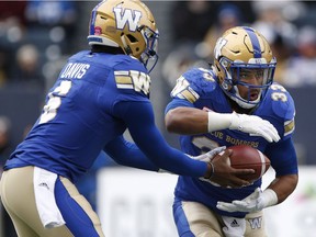 Winnipeg Blue Bombers quarterback Dominique Davis (6) hands off to Andrew Harris (33) during the first half of CFL action against the BC Lions in Winnipeg Saturday, October 28, 2017. THE CANADIAN PRESS/John Woods ORG XMIT: JGW112
John Woods,