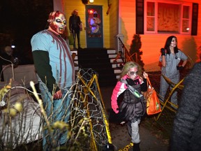 A girl runs past the zombies on Halloween.