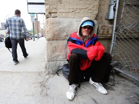 In this file photo a homeless man passes his time near Siloam Mission. A poll shows most Manitobans support government intervention raising people from poverty. Kevin King/Winnipeg Sun files