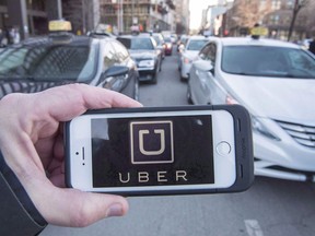 The Uber logo is seen in front of protesting taxi drivers at the Montreal courthouse, on February 2, 2016. Ride-hailing service Uber is backing down on a threat to shutter its Quebec operations, at least for now. The multinational announced Friday it won't pull the plug on its Quebec wing as planned this weekend because it hopes to reach a deal with the province's new transport minister in the coming months. THE CANADIAN PRESS/Ryan Remiorz ORG XMIT: CPT113

EDS NOTE A FILE PHOTO
Ryan Remiorz,