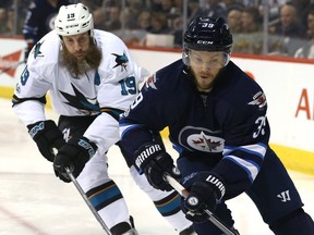 Winnipeg Jets defenceman Toby Enstrom (right) is pursued by San Jose Sharks centre Joe Thornton in Winnipeg on Mon., March 6, 2017. Kevin King/Winnipeg Sun/Postmedia Network
Kevin King, Kevin King/Winnipeg Sun