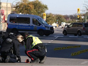 Police investigate at the scene of a fatal motor vehicle collision on Main Street near Sutherland Avenue in Winnipeg on Wed., Oct. 11, 2017. Const. Justin Holz, 34, was charged with impaired driving causing death after a pedestrian was struck and killed at the intersection on Oct. 10. Kevin King/Winnipeg Sun/Postmedia Network ORG XMIT: POS1710111520310109
Kevin King, Kevin King/Winnipeg Sun