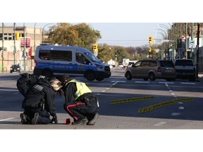 Police investigate at the scene of a fatal motor vehicle collision on Main Street near Sutherland Avenue in Winnipeg on Wed., Oct. 11, 2017. Const. Justin Holz, 34, was charged with impaired driving causing death after a pedestrian was struck and killed at the intersection on Oct. 10. Kevin King/Winnipeg Sun/Postmedia Network ORG XMIT: POS1710111520310109
Kevin King, Kevin King/Winnipeg Sun