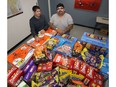 Jeff Wilson (left) and Garrett Courchene are the organizers of Halloweek at the Indian and Metis Friendship Centre on Robinson Street in Winnipeg. They are putting out a call for donations of Halloween candy. The centre is expecting as many as 1,200 children and this is what their pile looks like as of Wed., Oct. 18, 2017. Kevin King/Winnipeg Sun/Postmedia Network
Kevin King, Kevin King/Winnipeg Sun