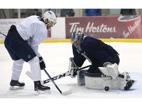 Goaltender Connor Hellebuyck stops centre Bryan Little at close range during Winnipeg Jets practice at Bell MTS Iceplex in Winnipeg on Mon., Oct. 23, 2017. Kevin King/Winnipeg Sun/Postmedia Network
Kevin King, Kevin King/Winnipeg Sun