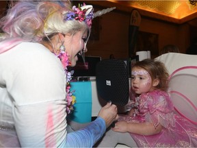 Rielle Swayze, 2, checks out her painted face during the Capes & Crowns Masquerade for Cystic Fibrosis at the Fort Garry Hotel in Winnipeg on Sun., Oct. 29, 2017. Funds raised went toward research and care for those living with cystic fibrosis in the community.