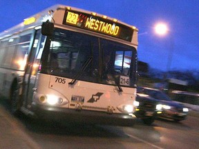 A Winnipeg Transit bus heads west on Portage Avenue.