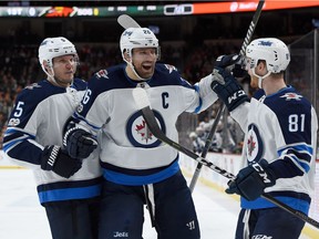 Captain Blake Wheeler (centre) says learning about the Winnipeg Jets' past is having an impact on the present.