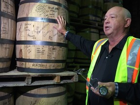 Jim Boyko discusses the making of Crown Royal, beside barrels that Diageo allows people who tour the facility to autograph. 
David Larkins/Winnipeg Sun
