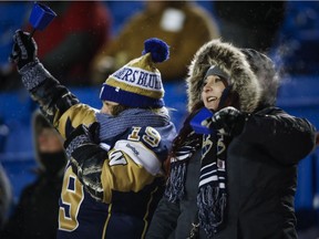 Winnipeg Blue Bombers fans cheer a touchdown during CFL football action against the Calgary Stampeders, in Calgary earlier this month.