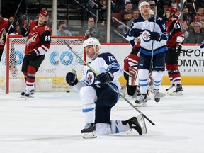 Jets’ Matt Hendricks celebrates after scoring a goal against the Phoenix Coyotes during the second period in Glendale, Ariz.