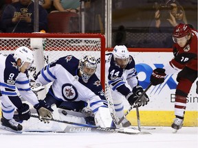 Arizona Coyotes center Christian Dvorak (18) gets his shot stopped by Winnipeg Jets center Andrew Copp (9), goalie Steve Mason (35) and defenseman Josh Morrissey (44) during the first period of an NHL hockey game Saturday, Nov. 11, 2017, in Glendale, Ariz. (AP Photo/Ross D. Franklin) ORG XMIT: PNJ101
Ross D. Franklin, AP