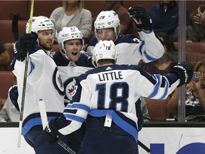 Winnipeg Jets left wing Nikolaj Ehlers (second from left) celebrates scoring a goal against the Anaheim Ducks, with center Bryan Little (18), right wing Patrik Laine (29), and defenceman Ben Chiarot, left, during the first period in Anaheim on Friday.