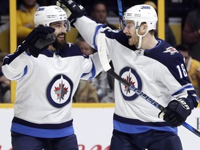 The red-hot Mathieu Perreault and his Winnipeg Jets clash with the Chicago Blackhawks at Bell MTS Place on Thursday. AP Photo/Mark Humphrey