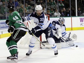 Connor Hellebuyck, Toby Enstrom, Gemel Smith

Dallas Stars center Gemel Smith (46) is pushed away from the net by Winnipeg Jets defenseman Toby Enstrom (39) of Sweden as goalie Connor Hellebuyck (37) collects a loose puck in the first period of an NHL hockey game, Monday, Nov. 6, 2017, in Dallas. (AP Photo/Tony Gutierrez) ORG XMIT: DNA102 ORG XMIT: POS1711062028067566
Tony Gutierrez, AP