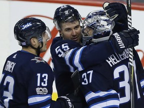 Winnipeg Jets' Brandon Tanev (13) and Mark Scheifele (55) celebrate defeating the New Jersey Devils in NHL action in Winnipeg on Saturday, November 18, 2017. THE CANADIAN PRESS/John Woods