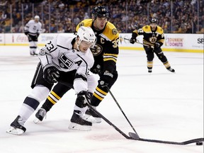 The Kings' Dustin Brown has his stick broken by Bruins defenceman Zdeno Chara during a game in Boston on Saturday, Oct. 28, 2017.
