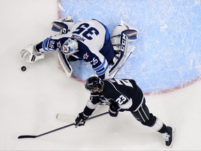 Los Angeles Kings right wing Dustin Brown, right, tries to get a shot in on Winnipeg Jets goalie Steve Mason during the first period of an NHL hockey game, Wednesday, Nov. 22, 2017, in Los Angeles. (AP Photo/Mark J. Terrill) ORG XMIT: LAS108