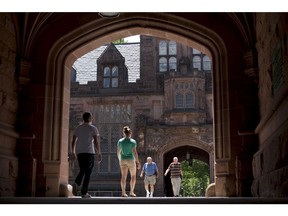 Pedestrians walk through arches of the East Pyne building on the Princeton University campus in Princeton, N.J., on Monday, June 21, 2010. (Emile Wamsteker/Bloomberg)