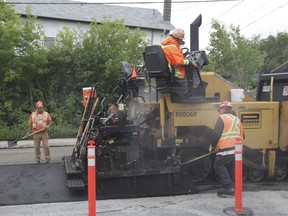 A road crew laying asphalt. 
Postmedia files