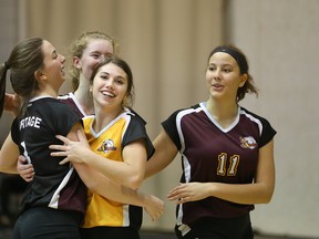 The Portage Collegiate Saints celebrate their victory over the Lord Selkirk Royals in a 2017 AAAA high school provincial volleyball semifinal at Investors Group Athletic Centre in Winnipeg on Wed., Nov. 29, 2017. Kevin King/Winnipeg Sun/Postmedia Network