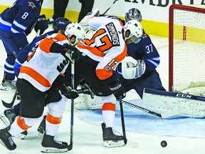 Philadelphia Flyers forward Wayne Simmonds can't corral a loose puck in front of Winnipeg Jets goaltender Connor Hellebuyck in Winnipeg on Thurs., Nov. 16, 2017. Kevin King/Winnipeg Sun/Postmedia Network