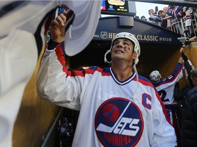 Winnipeg Jets centre Dale Hawerchuk signs autographs after the Heritage Classic alumni game against the Edmonton Oilers in Winnipeg on Sat., Oct. 22, 2016. Last week, Hawerchuk completed his last round of chemotherapy treatments in his fight against stomach cancer.