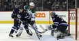 Jets centre Andrew Copp (left) ties up Stars forward Remi Elie in front of goalie Connor Hellebuyck last night. (Kevin King/Winnipeg Sun)