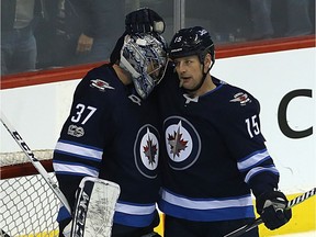 Winnipeg Jets centre Matt Hendricks (right) congratulates goaltender Connor Hellebuyck on a win over the Dallas Stars in Winnipeg on Thursday.