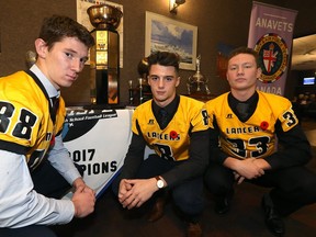 Dakota Lancers wide receiver Aidan Campbell, defensive back Andreas Kastellanos, and linebacker Noah Paulic (from left) pose with the ANAVETS Bowl during a Winnipeg High School Football League press conference at Anavets Assiniboia Unit 283 on Portage Avenue in Winnipeg on Tues., Nov. 7, 2017. The Lancers face the St. Paul's Crusaders at Investors Group Field on Thursday. Kevin King/Winnipeg Sun/Postmedia Network