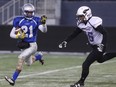 Oak Park Raiders #21 Ivan Mugisha runs clear of Vincent Massey Brandon #36 Kale Bercier in action at the Investors Group Field in Winnipeg on Thursday.