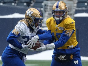 Quarterback Matt Nichols (right) hands the ball off to running back Andrew Harris during Winnipeg Blue Bombers practice. The Bombers should rest both for Saturday's game against Edmonton.