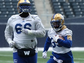 Running back Andrew Harris (right) carries the ball behind offensive tackle Stanley Bryant during Winnipeg Blue Bombers practice in Winnipeg on Wed., Nov. 8, 2017. Kevin King/Winnipeg Sun/Postmedia Network