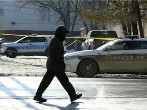 A pedestrian walks by a police scene on Ellice Avenue at McMicken Street on Mon., Nov. 13, 2017. Police said a 16-year-old male was stabbed Sunday night just before 10 p.m. after he was approached by a group of suspects. Kevin King/Winnipeg Sun/Postmedia Network
Kevin King, Kevin King/Winnipeg Sun