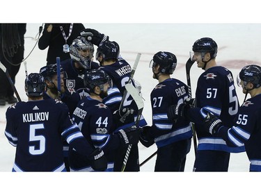 Winnipeg Jets goaltender Connor Hellebuyck (top left) is congratulated by teammates after the Jets beat the Phoenix Coyotes in Winnipeg on Tues., Nov. 14, 2017. Kevin King/Winnipeg Sun/Postmedia Network
Kevin King, Kevin King/Winnipeg Sun