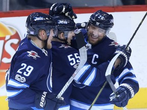 Patrik Laine, Mark Scheifele and Blake Wheeler (from left) of the Winnipeg Jets celebrate Scheifele's tying goal in the dying seconds against the Philadelphia Flyers in Winnipeg on Thurs., Nov. 16, 2017. Kevin King/Winnipeg Sun/Postmedia Network