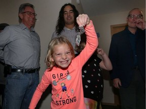 With father Todd Gauthier behind them, Carmin Gauthier shows off the key for the first Habitat for Humanity home turned over from the Jimmy and Rosalynn Carter Work Project at 264 Lyle St., in Winnipeg, on Mon., Nov. 20, 2017. Kevin King/Winnipeg Sun/Postmedia Network
Kevin King, Kevin King/Winnipeg Sun