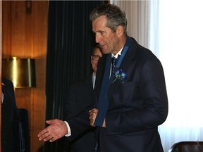 Premier Brian Pallister extends one hand, with the other in a sling, prior to the opening of a new session with the throne speech at the Manitoba Legislative Building on Tues., Nov. 21, 2017. Kevin King/Winnipeg Sun/Postmedia Network
Kevin King, Kevin King/Winnipeg Sun