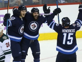 Jets forward Mathieu Perreault (centre) has a pretty good sense Tuesday's game against Washington will probably go down as a red-letter day.