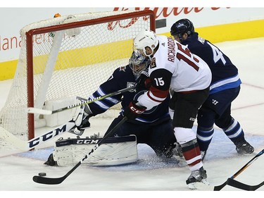 Winnipeg Jets goaltender Connor Hellebuyck makes a stop on Phoenix Coyotes centre Brad Richardson with Josh Morrissey defending in Winnipeg on Tues., Nov. 14, 2017. Kevin King/Winnipeg Sun/Postmedia Network
Kevin King, Kevin King/Winnipeg Sun